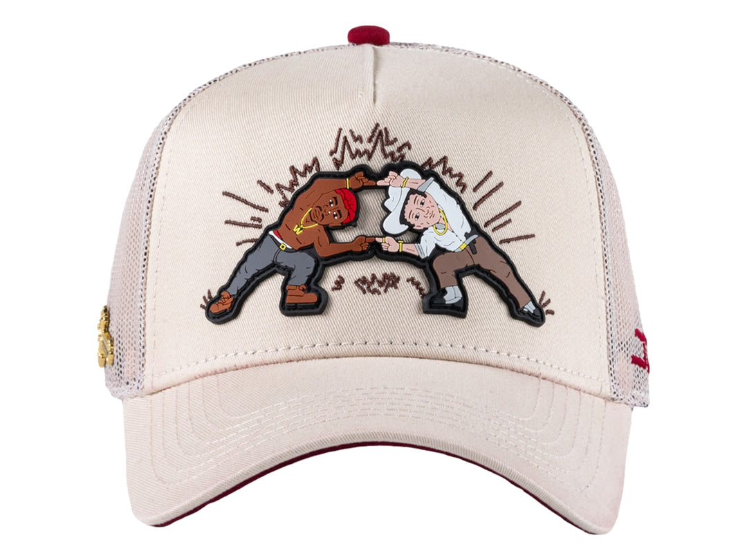 Gorra trucker beige con parche gráfico frontal y malla trasera.