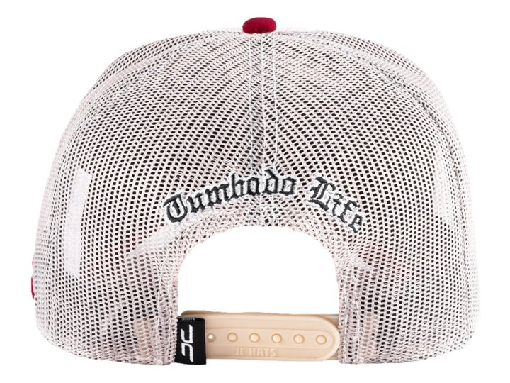 Gorra trucker beige con parche gráfico frontal y malla trasera.