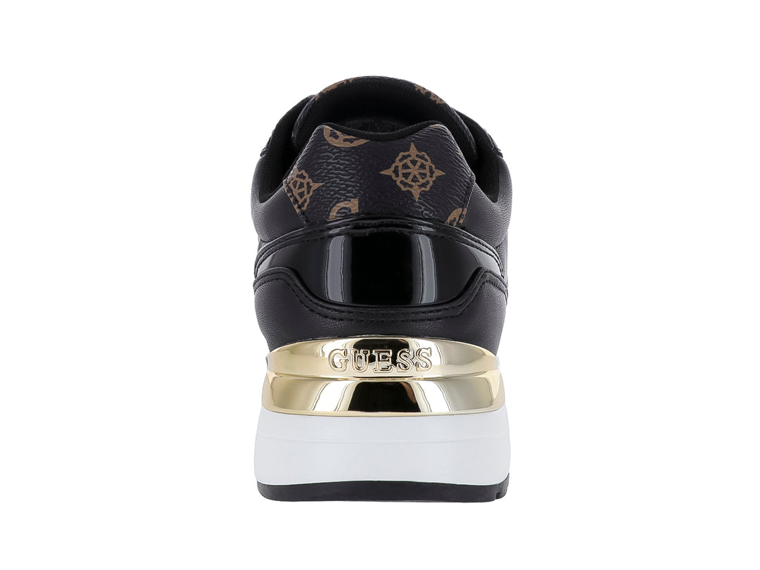 Tenis negros Guess con detalles dorados, suela blanca y estampado decorativo en la punta y talón.