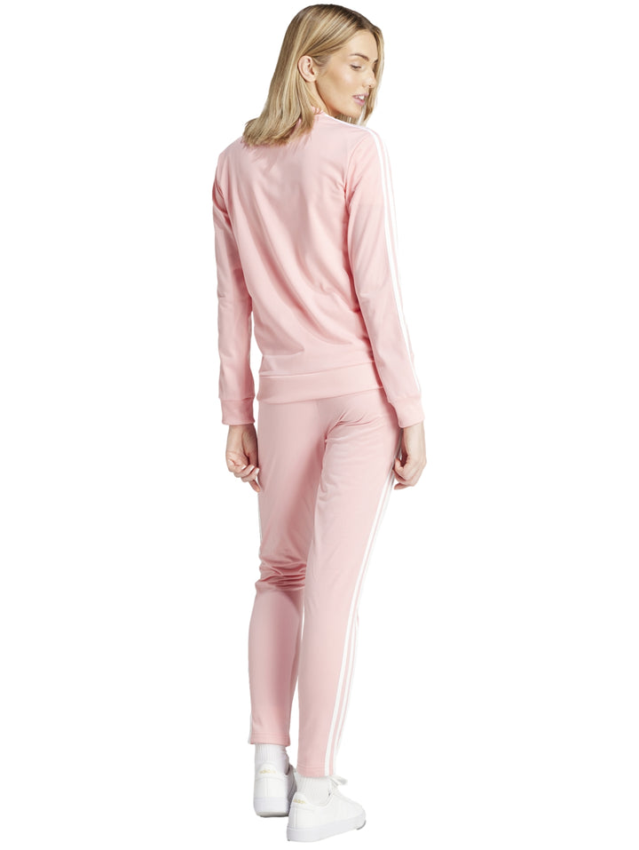 Conjunto deportivo Adidas color rosa claro con tres franjas blancas laterales, incluye chaqueta y pantalón para mujer.