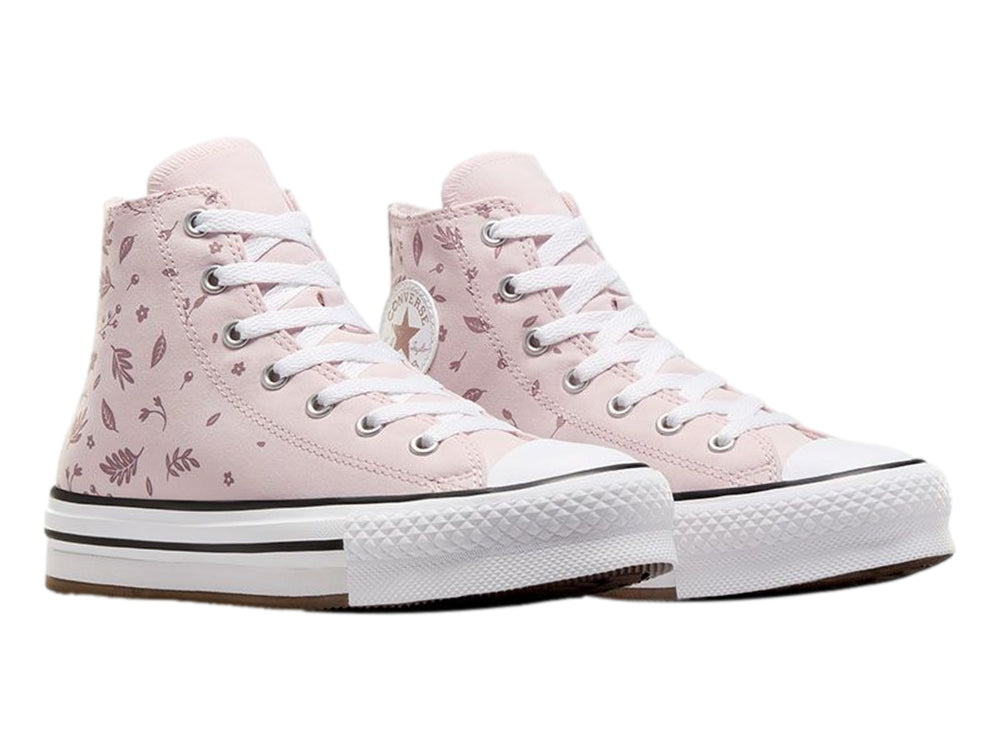 Tenis Converse rosa con estampado de hojas y suela de plataforma blanca.