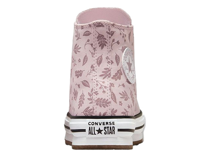 Tenis Converse rosa con estampado de hojas y suela de plataforma blanca.