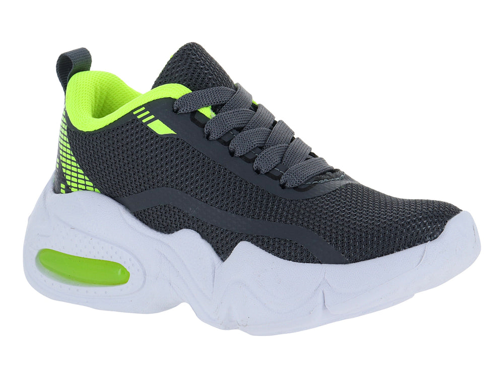 Tenis deportivos infantiles color gris con detalles en amarillo neón y suela blanca gruesa.