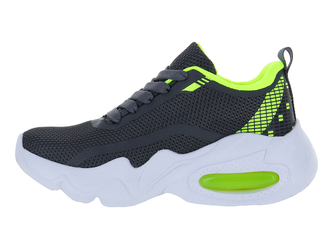 Tenis deportivos infantiles color gris con detalles en amarillo neón y suela blanca gruesa.
