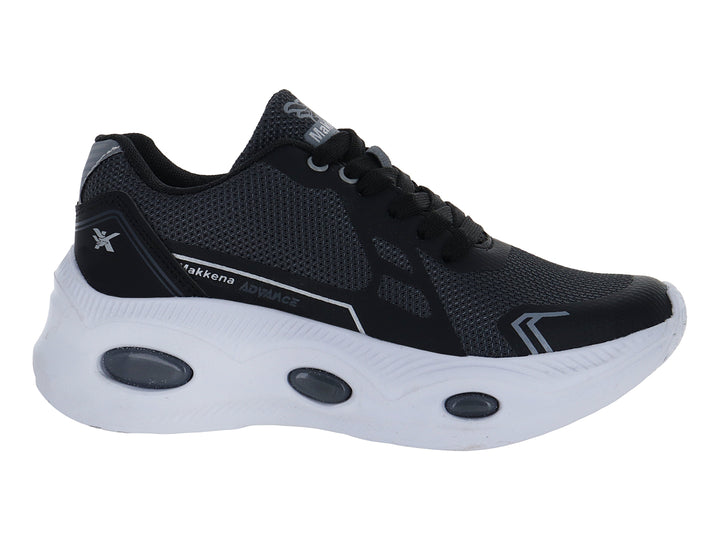 Zapato deportivo infantil color negro con suela blanca y detalles en gris.