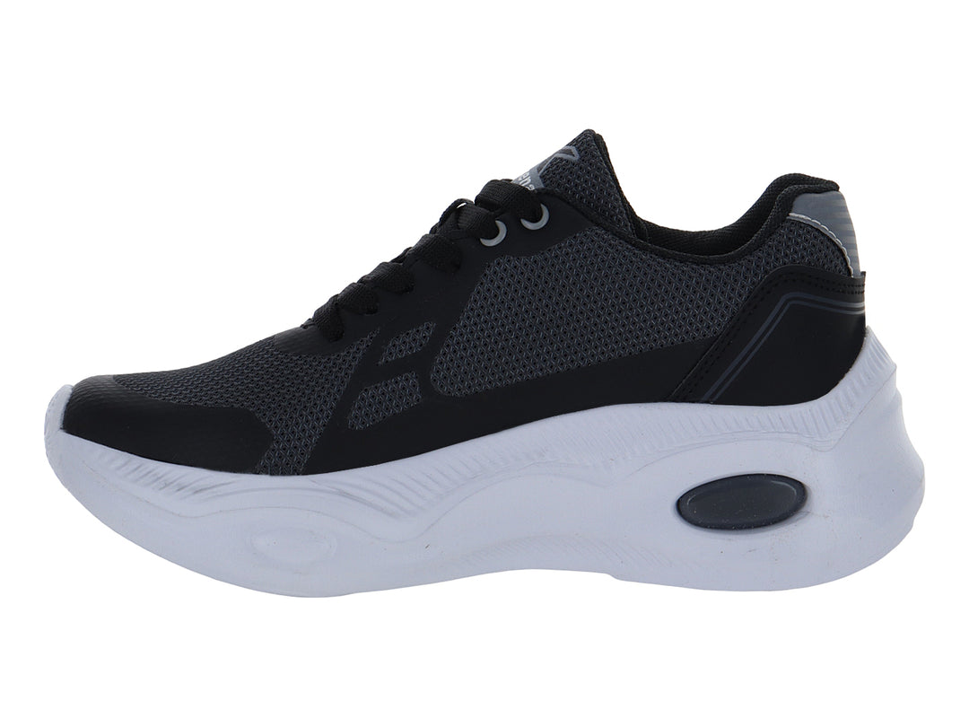 Zapato deportivo infantil color negro con suela blanca y detalles en gris.