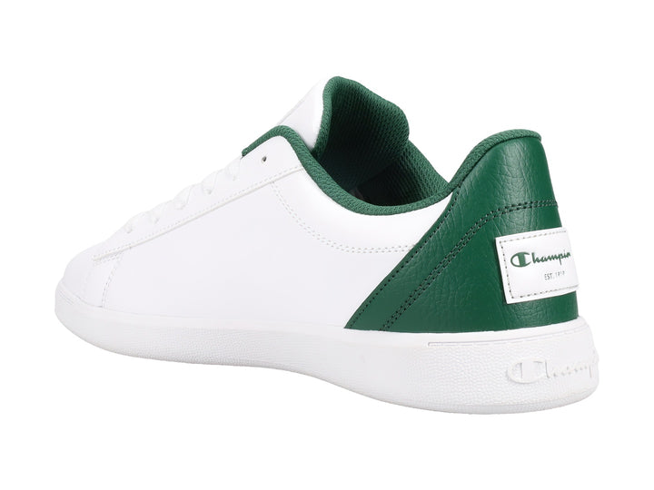 Tenis Champion color blanco con detalles en verde oscuro y beige, diseño deportivo de perfil bajo.