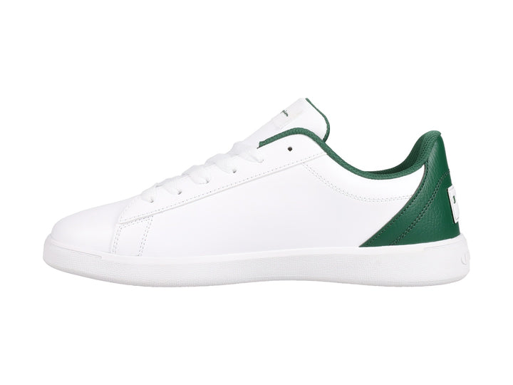 Tenis Champion color blanco con detalles en verde oscuro y beige, diseño deportivo de perfil bajo.