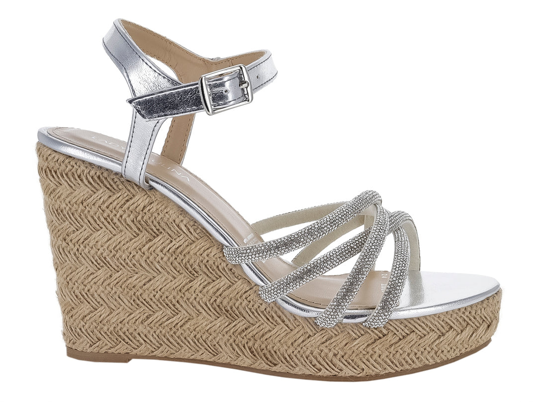 Sandalia de plataforma cuña color plata con tiras brillantes y tobillera con hebilla para mujer.