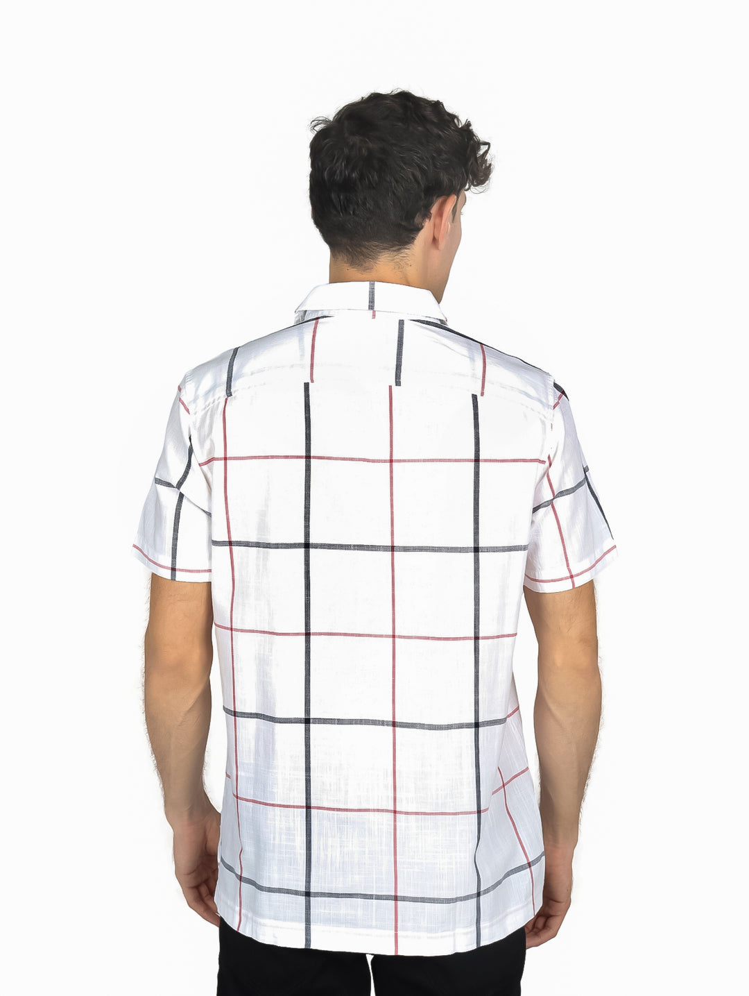 Hombre vistiendo una camisa blanca de manga corta con estampado de cuadros negros y rojos.