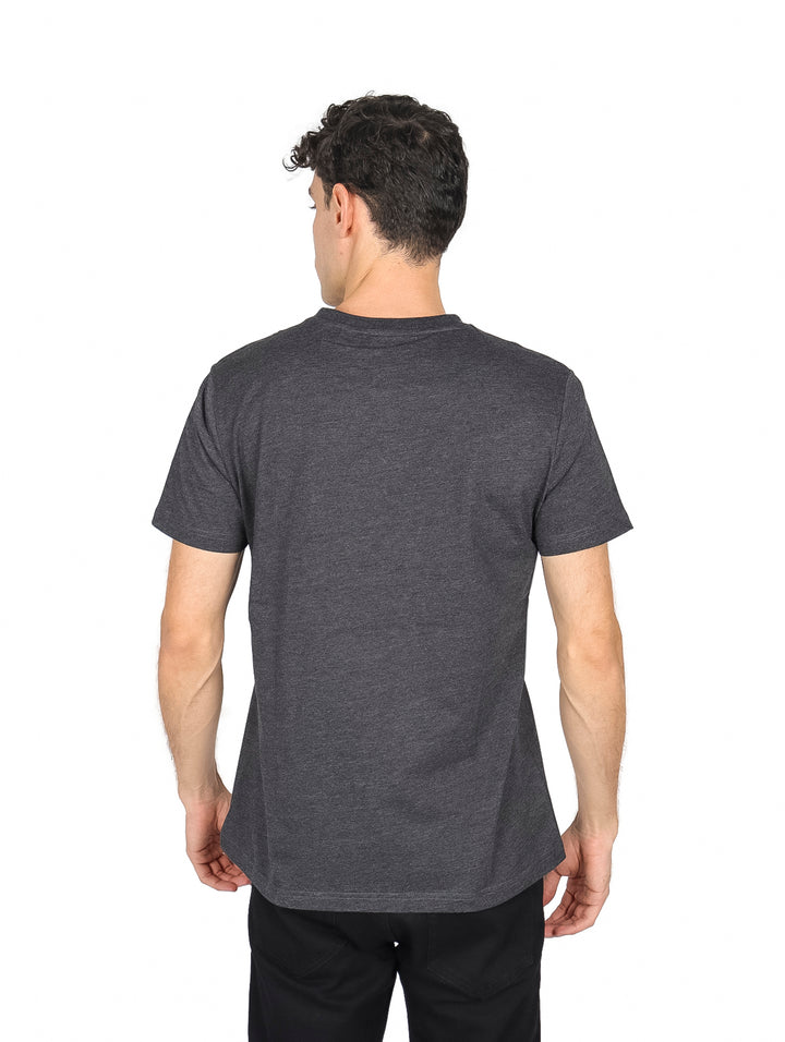 Hombre vistiendo una playera de color gris oscuro con cuello redondo y manga corta.