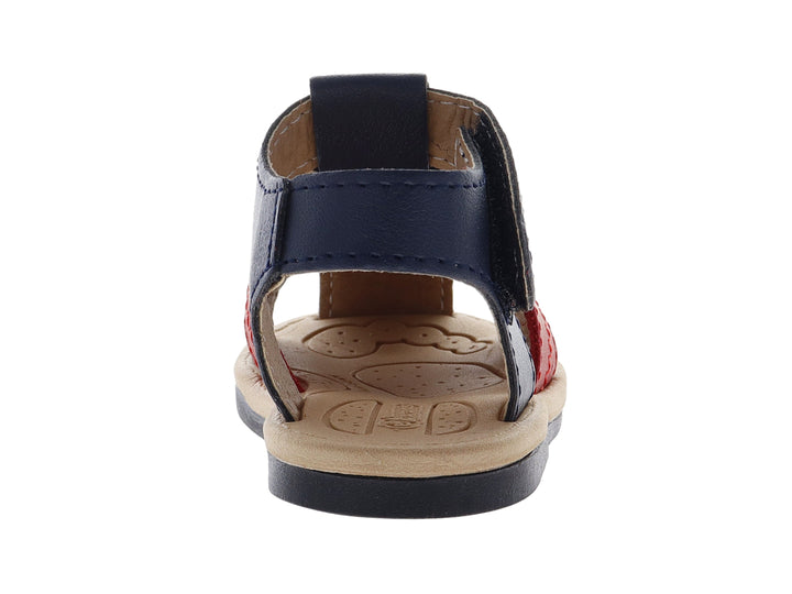 Sandalia infantil de color azul con una banda roja y suela beige, diseño casual con cierre de velcro.