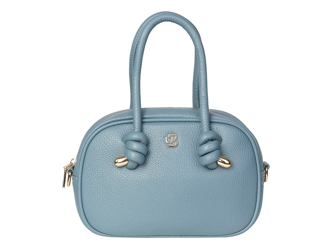 Bolso de mano color azul jeans con asas superiores y detalles dorados en forma de nudos.