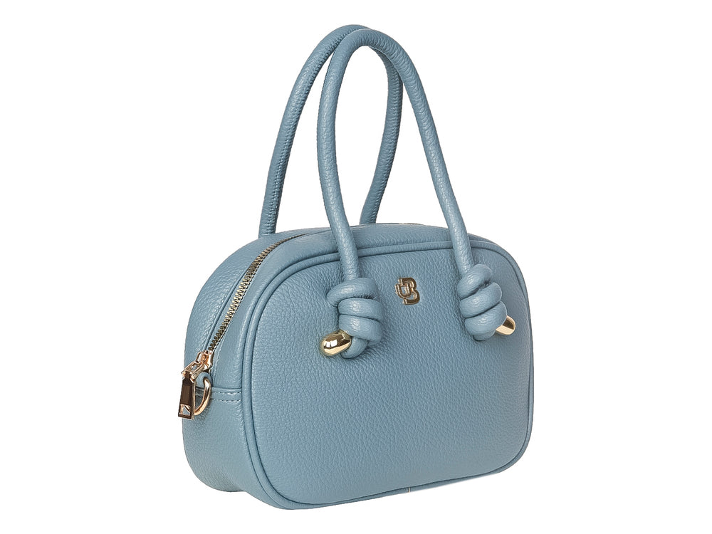 Bolso de mano color azul jeans con asas superiores y detalles dorados en forma de nudos.