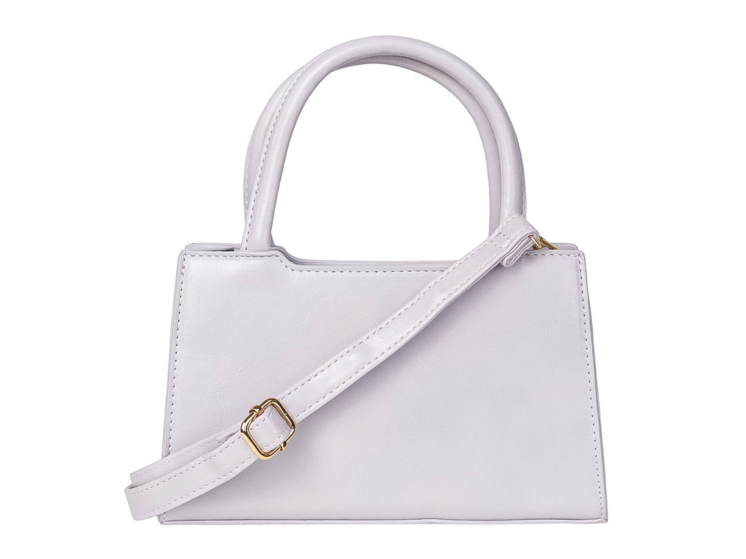 Bolso de mano color morado claro con un moño decorativo grande en la parte frontal y asas cortas.