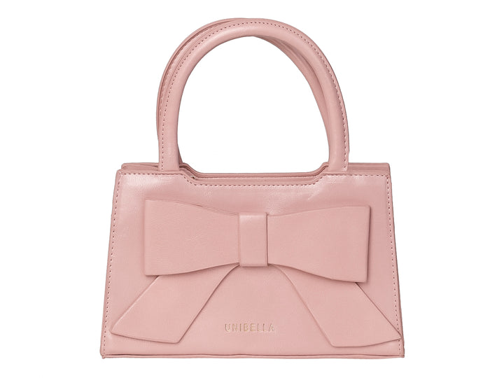 Bolso de mano color rosa con un moño decorativo grande en la parte frontal y asa corta.