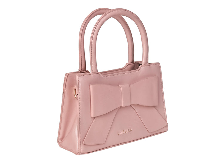 Bolso de mano color rosa con un moño decorativo grande en la parte frontal y asa corta.