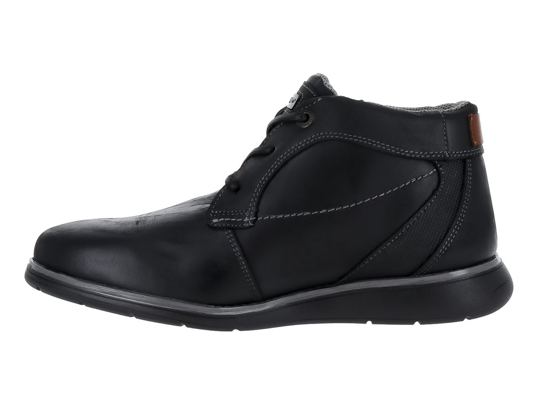 Zapato casual de cuero negro con cordones y suela gris oscuro.