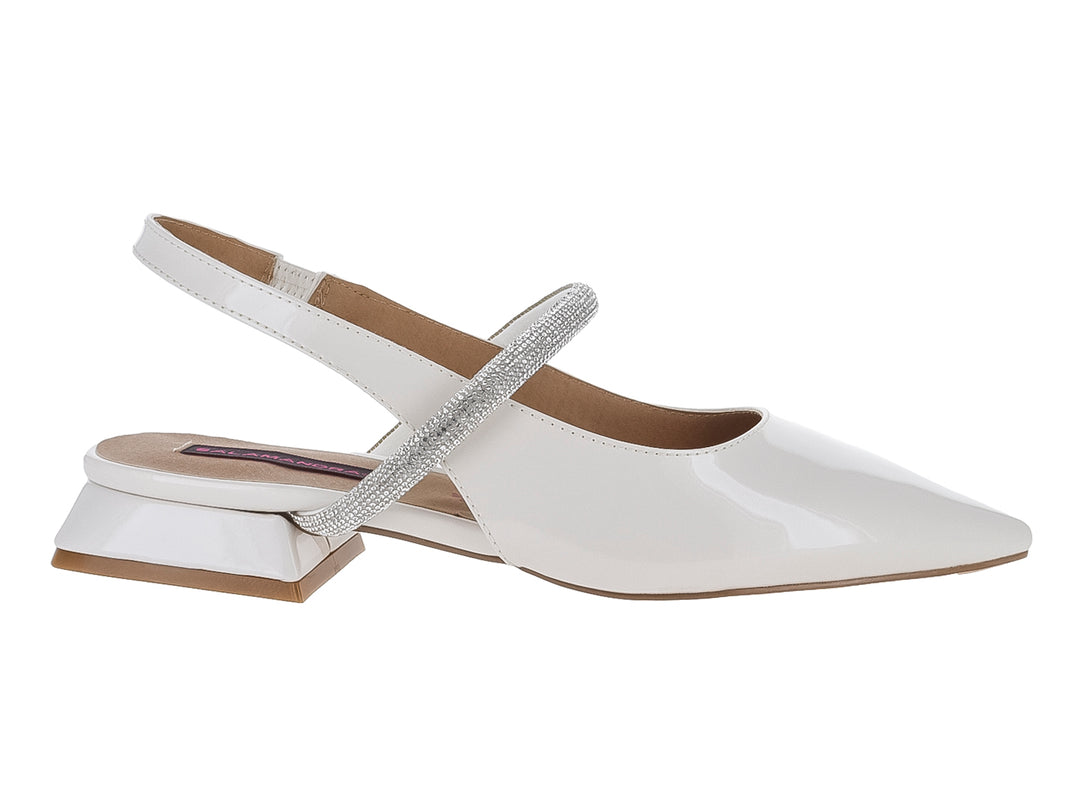 Zapato blanco de charol con punta fina, tacón bajo cuadrado y correa brillante en el empeine.