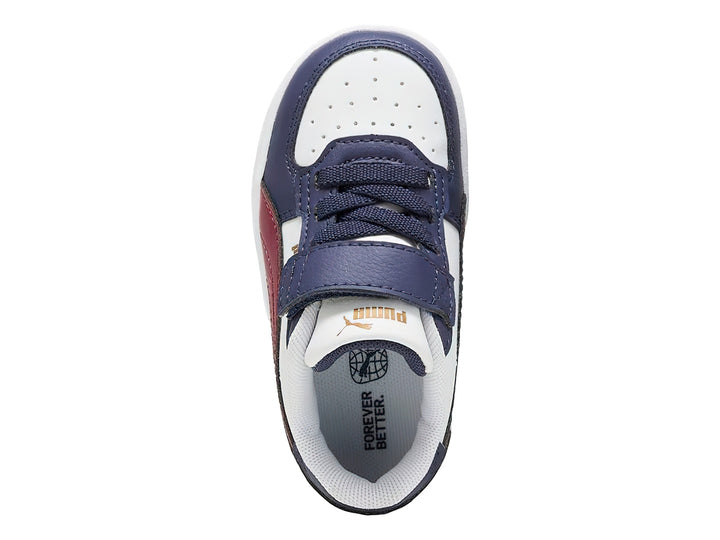 Tenis PUMA infantiles en colores blanco y azul marino con franja roja y cierre de velcro.