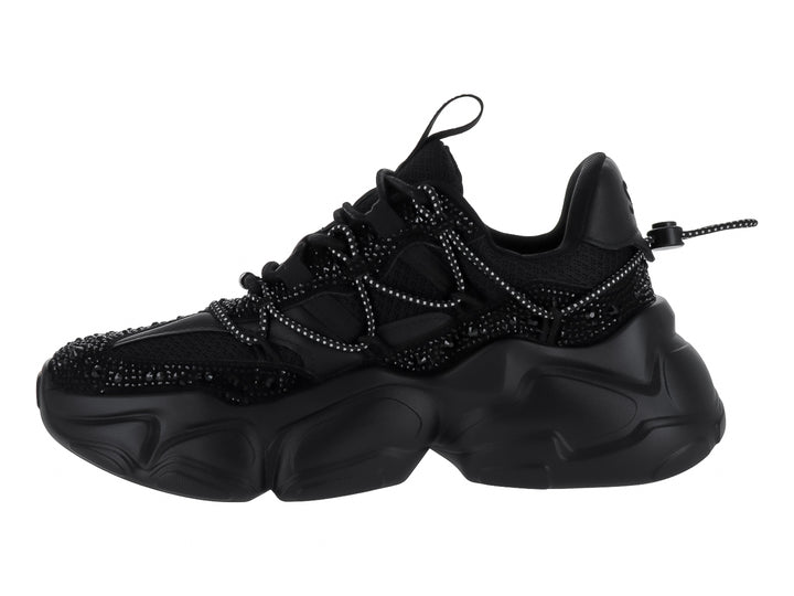Tenis negros de terciopelo Steve Madden con suela chunky y detalles brillantes.