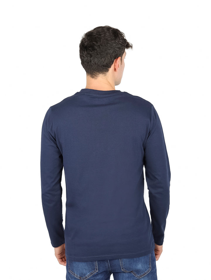 Hombre vistiendo camiseta de manga larga color azul oscuro con estampado gráfico frontal.
