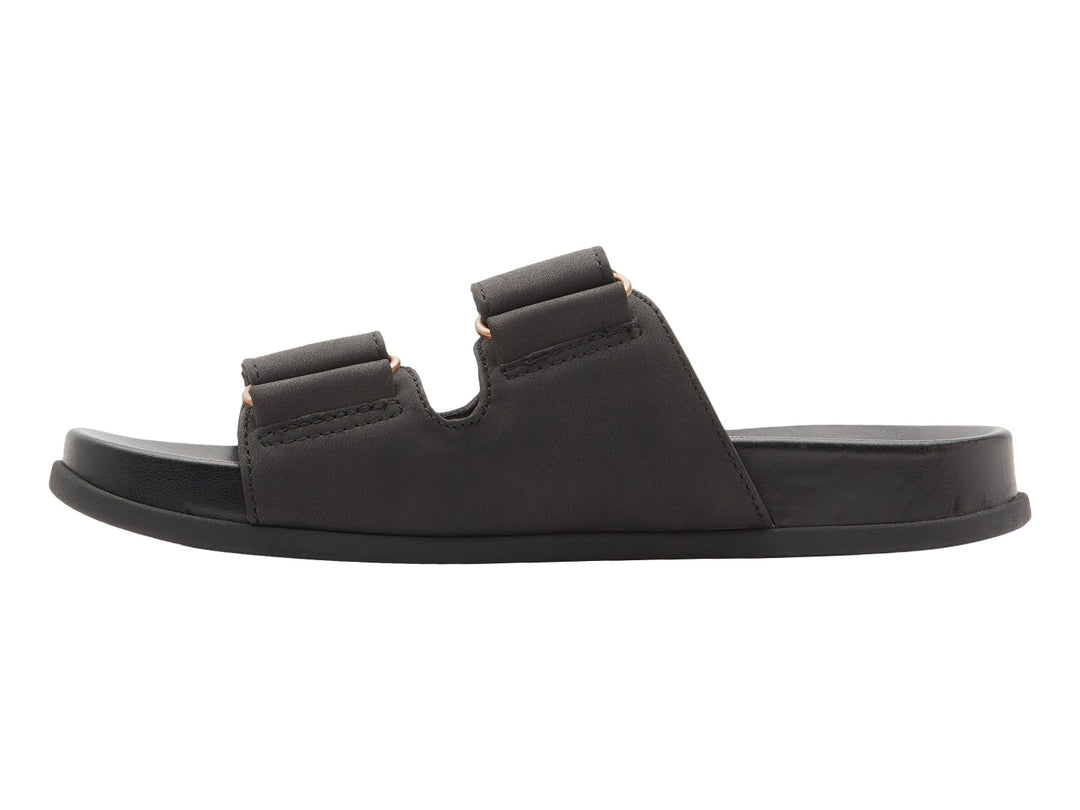Sandalia slide negra con dos correas y botones decorativos dorados.