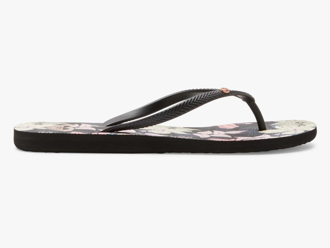 Sandalias planas ROXY color azul índigo con estampado floral y tiras negras.