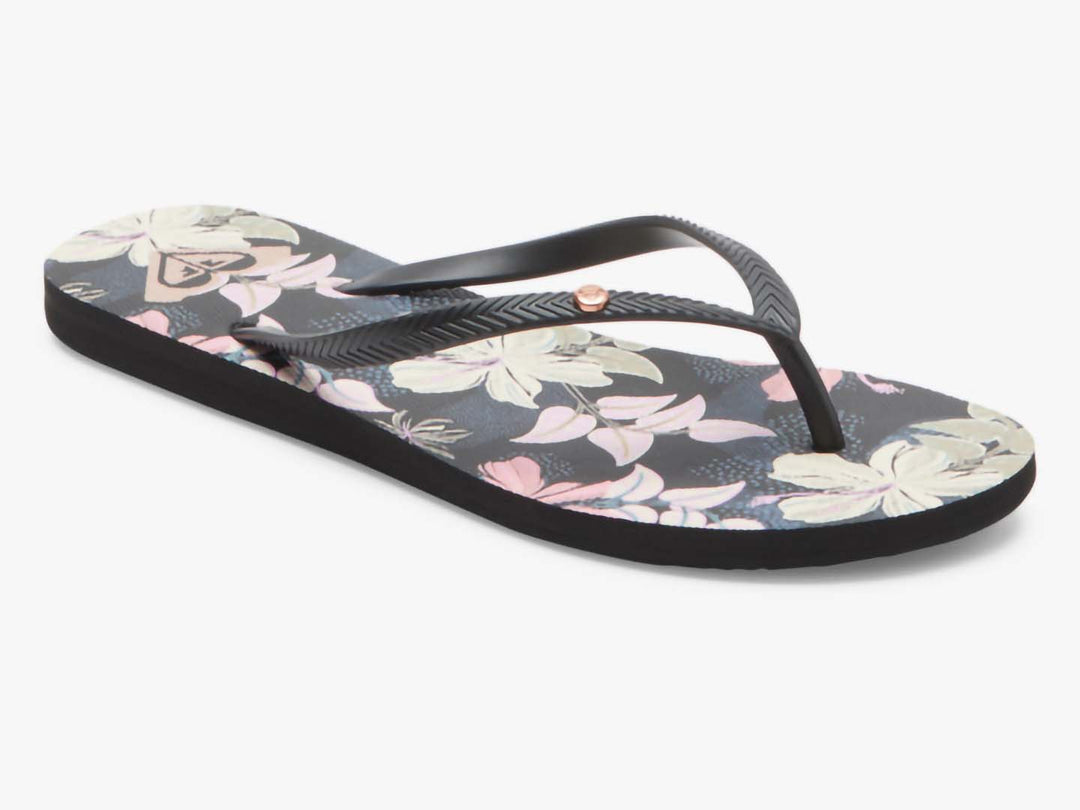 Sandalias planas ROXY color azul índigo con estampado floral y tiras negras.