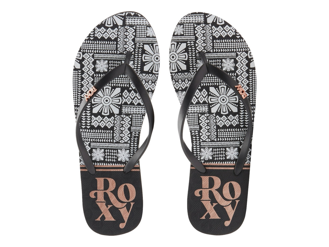Sandalias Roxy de dedo con correas negras y plantilla blanca con estampado en negro.