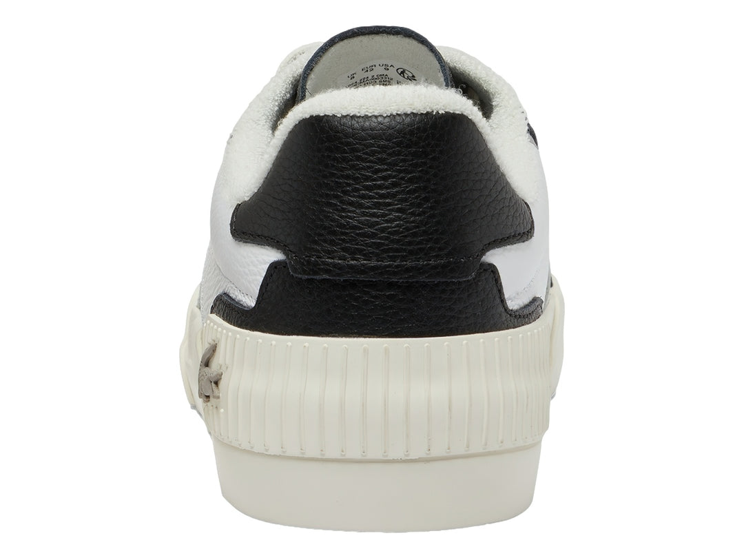 Tenis Lacoste blancos con detalles en negro y gris, suela blanca ancha.