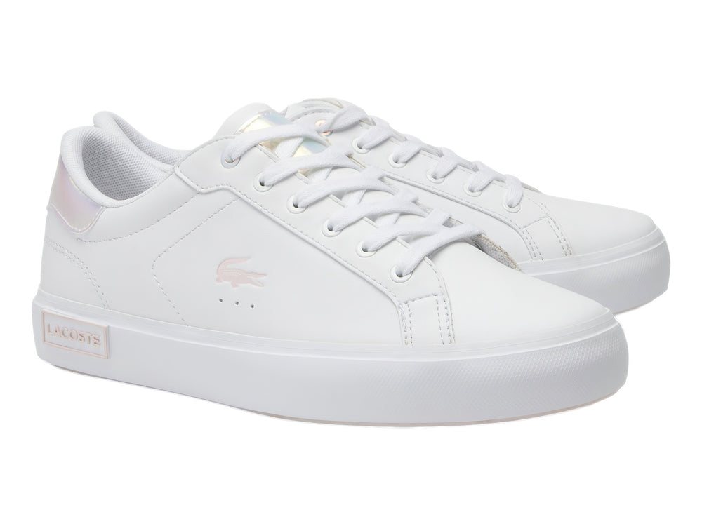 Tenis Lacoste blancos de corte bajo con detalles iridiscentes en el talón y suela blanca.