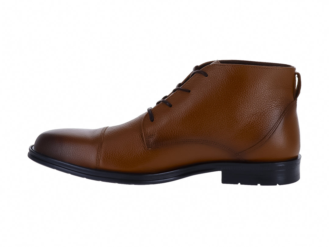 Botín de cuero color miel con cordones y suela negra para hombre.