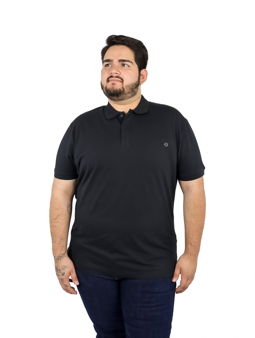 Hombre vistiendo una playera tipo polo de color negro de manga corta.