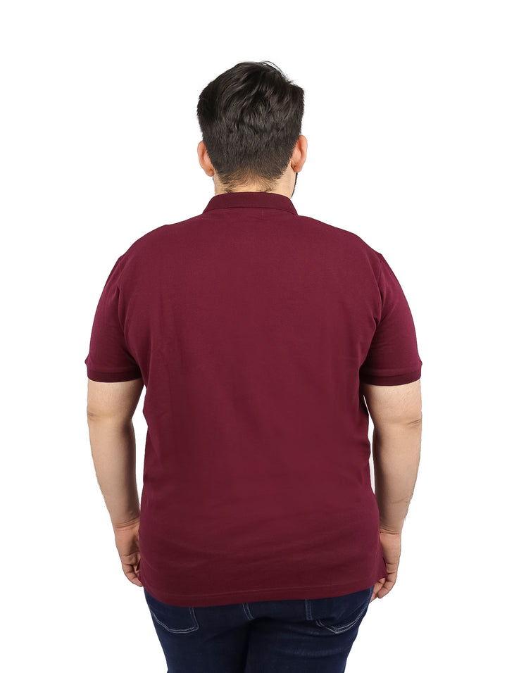 Hombre vistiendo playera tipo polo color vino de manga corta.