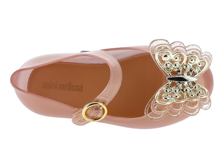 Zapato Mini Melissa color oro con correa y adorno de mariposa brillante en la punta para Niña.