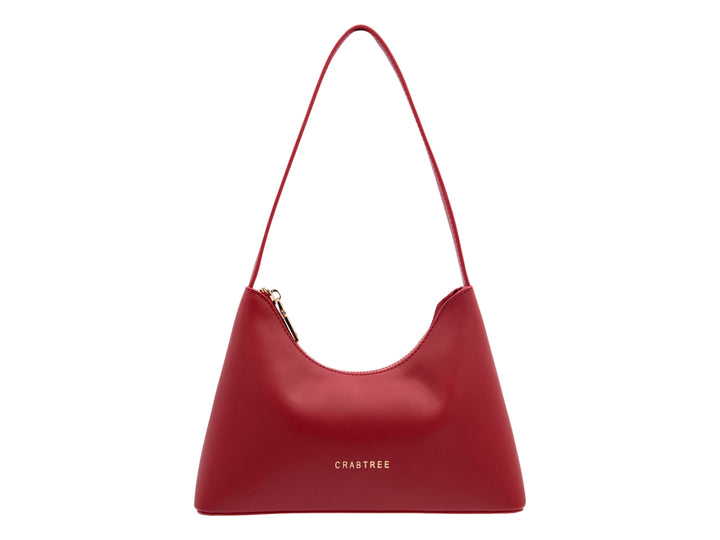 Bolso de hombro color rojo marca Crabtree con diseño curvo, asa larga y acabado liso.