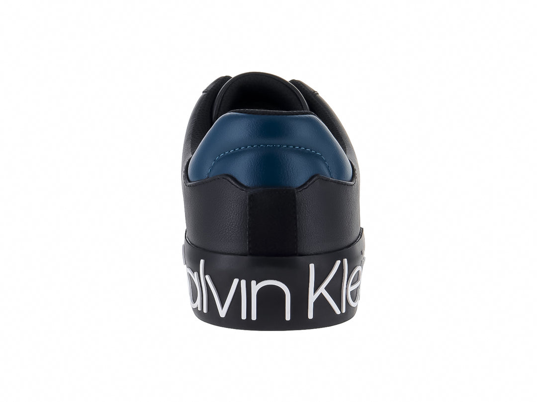 Tenis negros Calvin Klein con suela blanca y detalle azul en el talón.