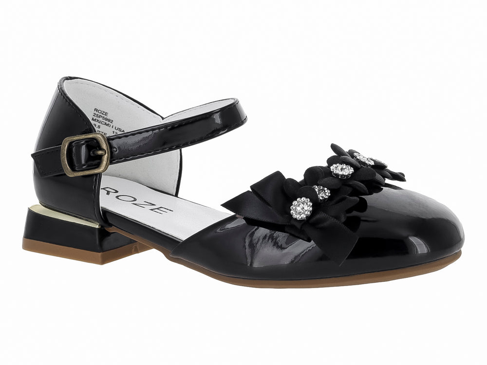 Zapato negro de charol para niña con moño decorativo, pedrerías y correa ajustable al tobillo.