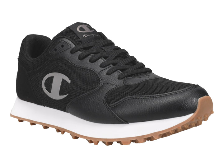 Tenis Champion color negro con suela blanca y base de goma color miel.