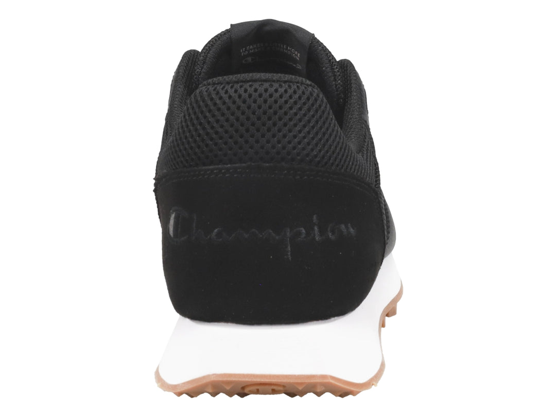 Tenis Champion color negro con suela blanca y base de goma color miel.