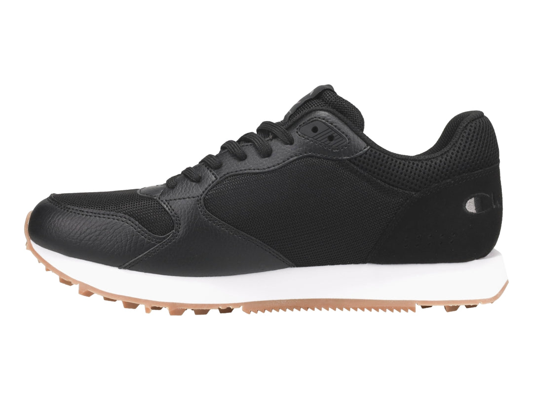 Tenis Champion color negro con suela blanca y base de goma color miel.