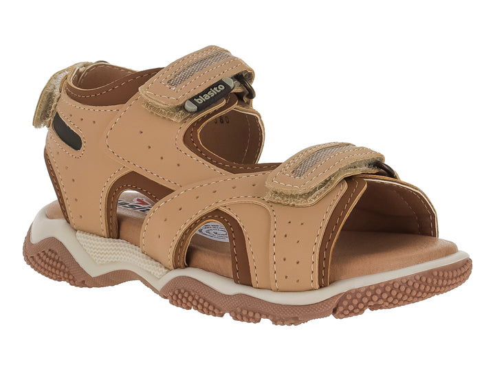 Sandalia infantil color camel con correas de velcro y suela robusta en tonos beige y café.