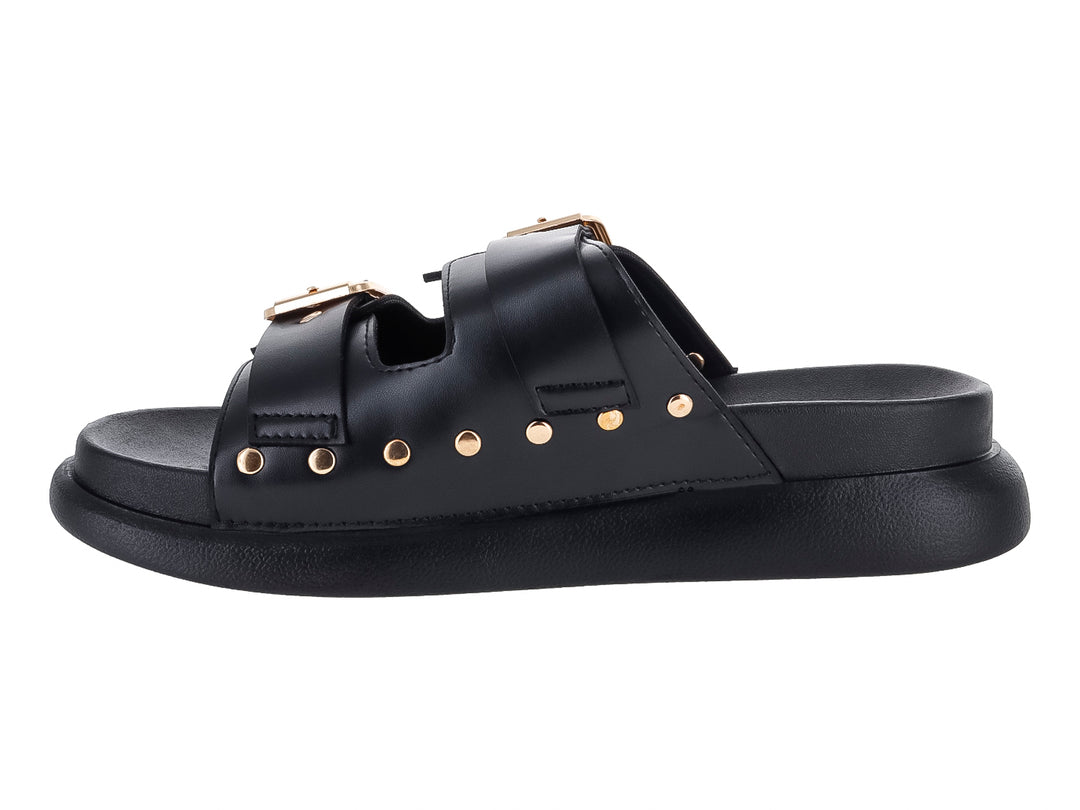 Sandalias negras de plataforma para niña con dos correas ajustables mediante hebillas doradas y detalles de ojetes.