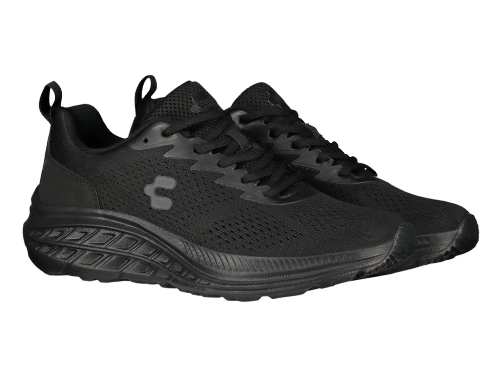 Tenis deportivos Charly en color negro total con suela gruesa y tejido transpirable.