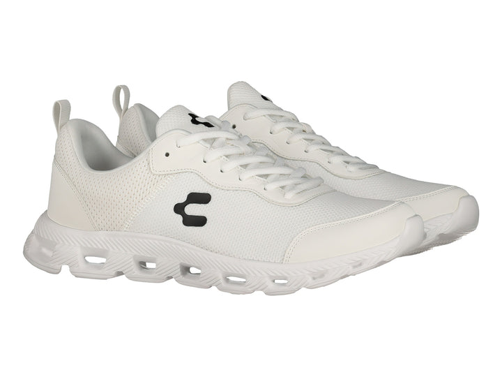 Tenis deportivos Charly de color blanco con logotipo negro en el costado y suela blanca.