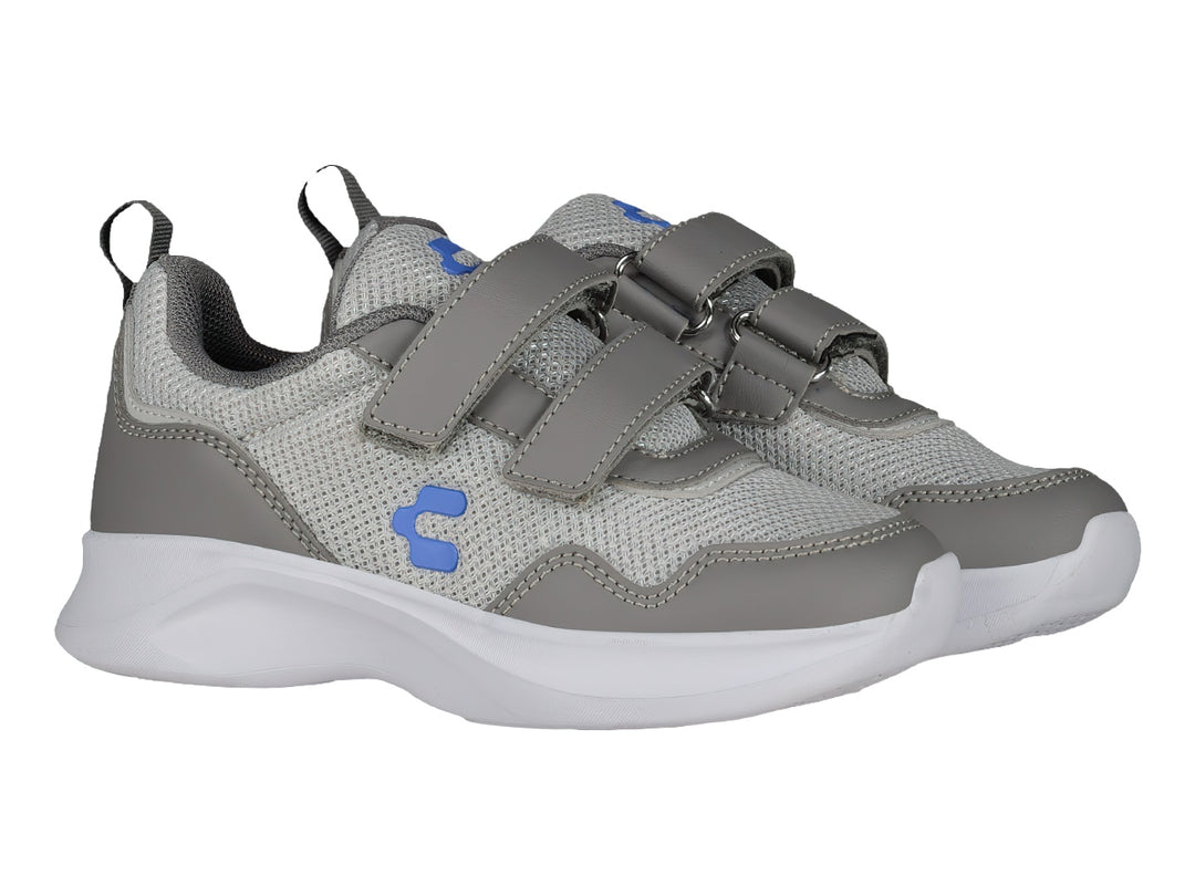 Tenis deportivos Charly color gris y blanco con cierre de velcro y suela blanca.