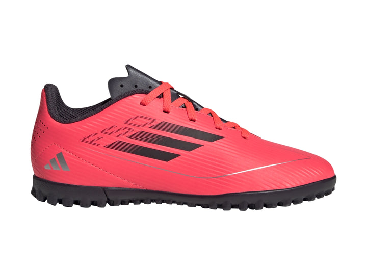 Tenis de fútbol Adidas F50 Club para niño en color rojo con detalles y suela en negro.