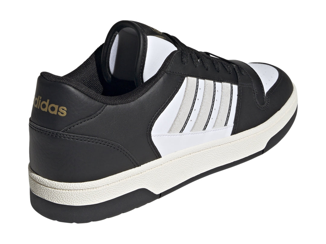 Tenis Adidas Break Start en colores negro y blanco con las tres franjas laterales características.
