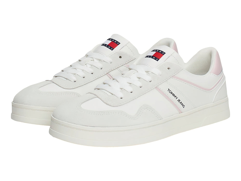 Tenis blancos Tommy Jeans con detalles en rosa pastel y suela blanca.